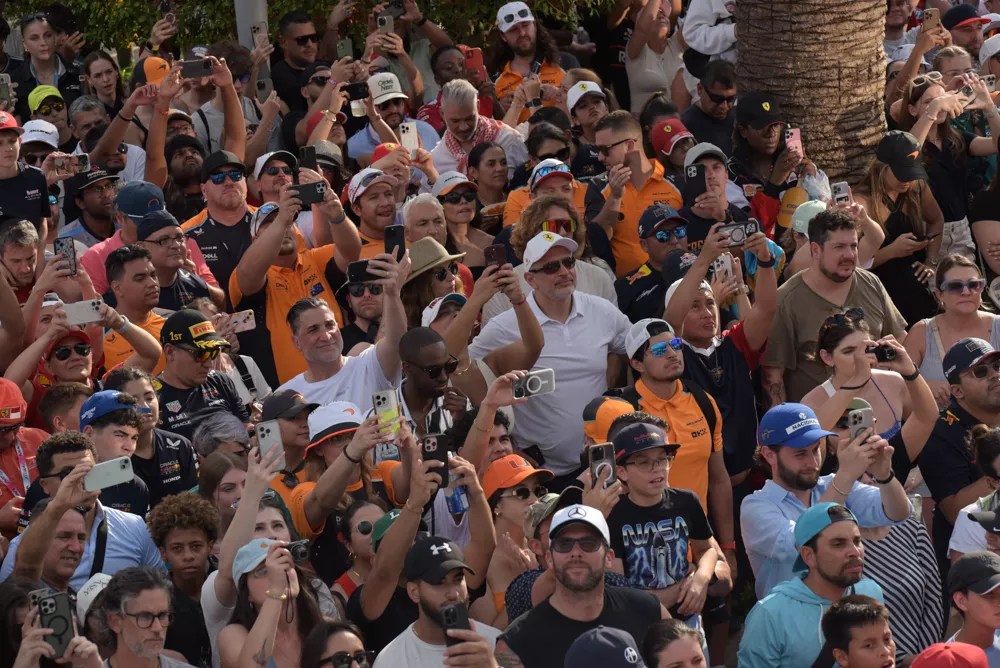crowd shot. a lot of people holding up their phones to capture the podium ceremony